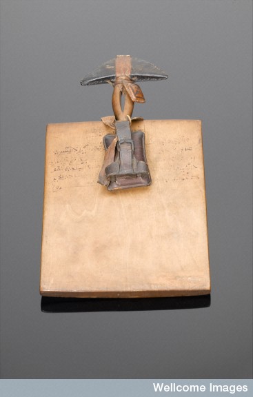 L0058783 Wooden Koranic board with two leather amuletic cases, Nigeri