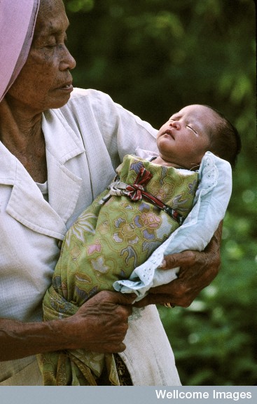 N0026598 Life in rural Indonesia. Baby and carer.