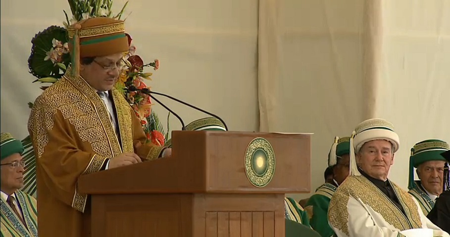 The Chief Guest, Dr Ishrat Ul Ebad Khan, the Governor of Sindh addressing the gathering at the 2013 Convocation of the Aga Khan University. The robe worn by the Chief Guest  is decorated with rich gold embroidery on a teak brown background. The headgear is brown in colour with a gold embroidered 5.5 cm band and a 2 cm wide secondary green band and a green and teak brown tassel.