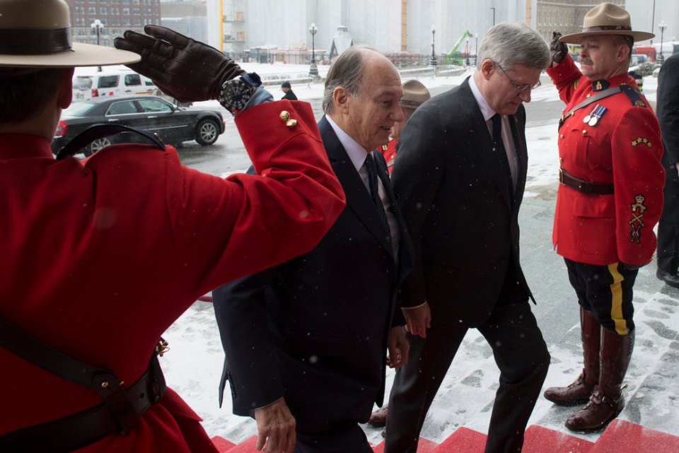 Officers of the Royal Mounted Canadian Police Salute as His Highness the Aga Khan and Prime Minister Harper walk up the stairs at Parliament Hill on Thursday, February 27, 2014. COC Photo by Jason Ransom 