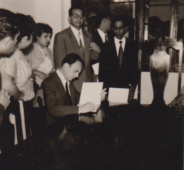 Ismaili leaders and Alwaez Jehangir Merchant (right) look on as Prince Aly Khan reviews student material during his visit to Lourenço Marques in 1958. Photo: Jehangir A. Merchant Collection.