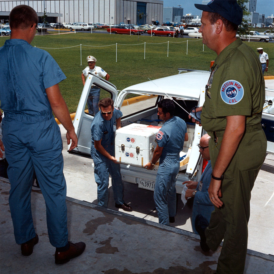 ap11-S69-39996_The first Apollo 11 sample return container, containing lunar surface material, is unloaded at the Lunar Receiving Laboratory, bldg 37, Manned Spacecraft Center.