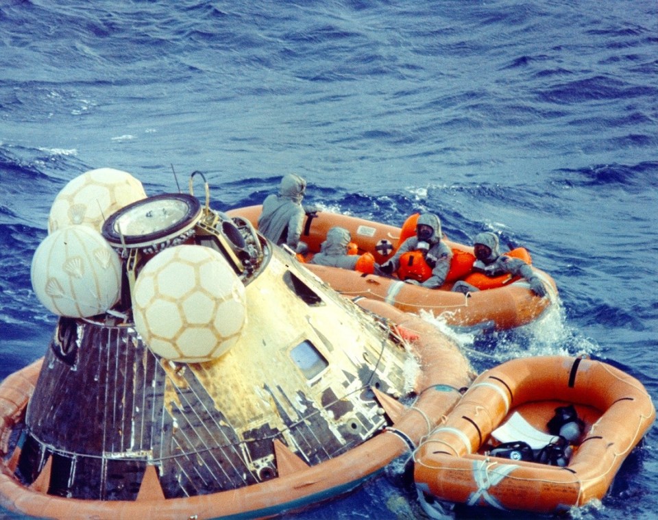 KSC-69PC-467_Apollo 11 crew in isolation suits after splashdown