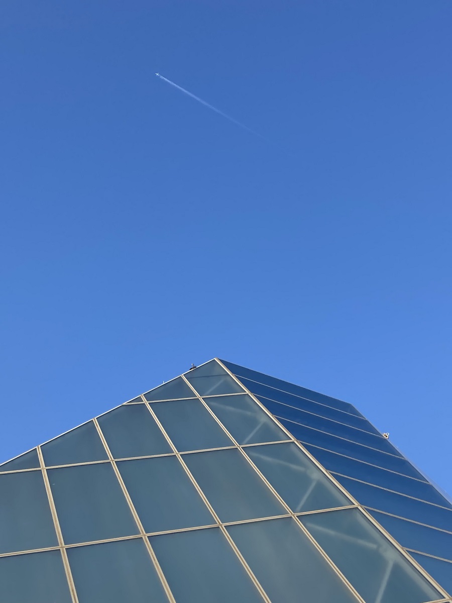 Ismaili Jamatkhana dome with jetliner overhead Simerg