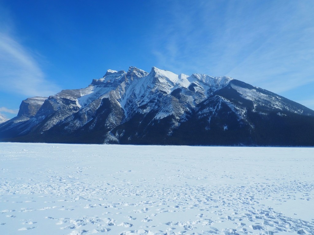 Another view of mountains around the frozen Lake Minnewanka, Banff National Park,
