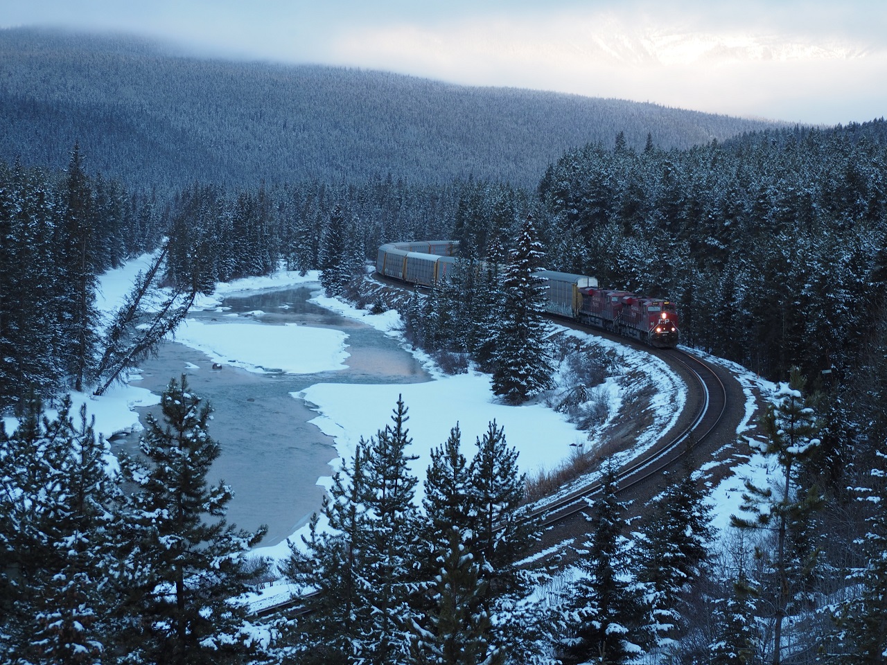 A CP freight trains passes through the beautiful Moran's Curve, with the Bow River flowing along the side; March 26-29, 2023. Photograph: Malik Merchant/Simerg Photos.