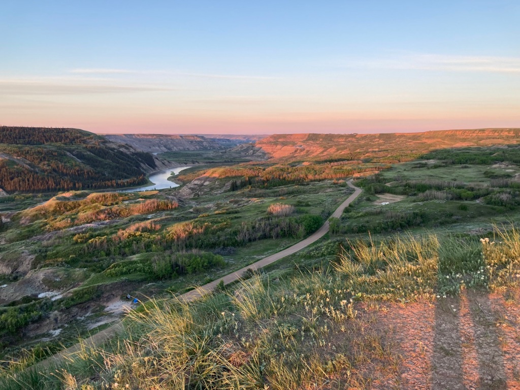 Views of the Badlands, the Red Deer River and the flat section of the gravel road that leads to the day-use area of Dry Island Buffalo Jump Provincial Park