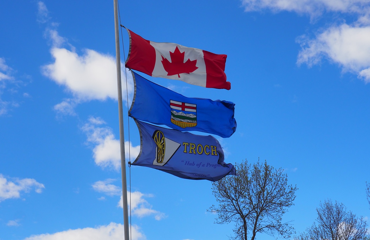 Flags of Canada, Alberta and Trochu at the Arboretum in Trochu, Alberta, May 31/June 1, 2024.
