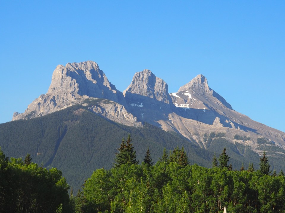 A view of Three Sisters from the Alpine Hostel, Canmore, Alberta, Canada, July 2026. Photograph: Malik Merchant / Simergphotos.